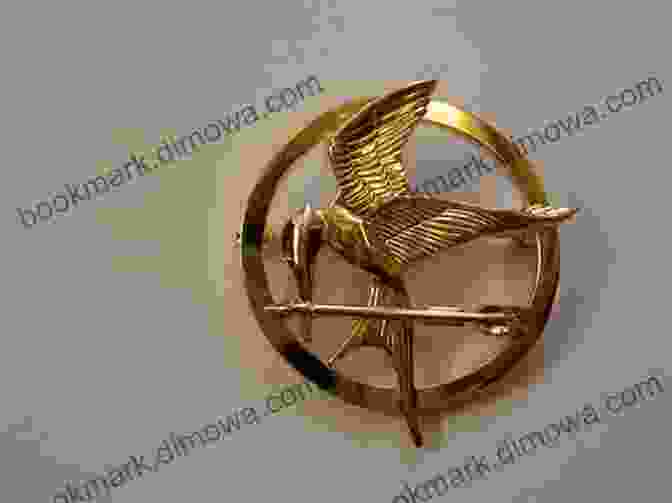 A Golden Mockingjay Pin, A Symbol Of Rebellion In The Hunger Games. The World Of The Hunger Games