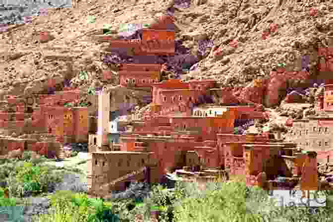 Trekkers Visiting A Traditional Berber Village, Surrounded By Mud Brick Houses And Colorful Textiles. The Mountains Look On Marrakech: A Trek Along The Atlas Mountains